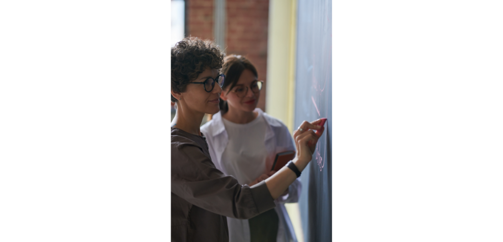 woman showing something to younger woman