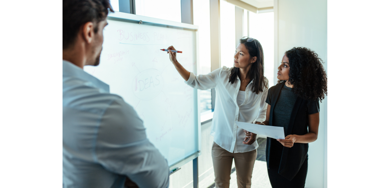 woman writing on white board