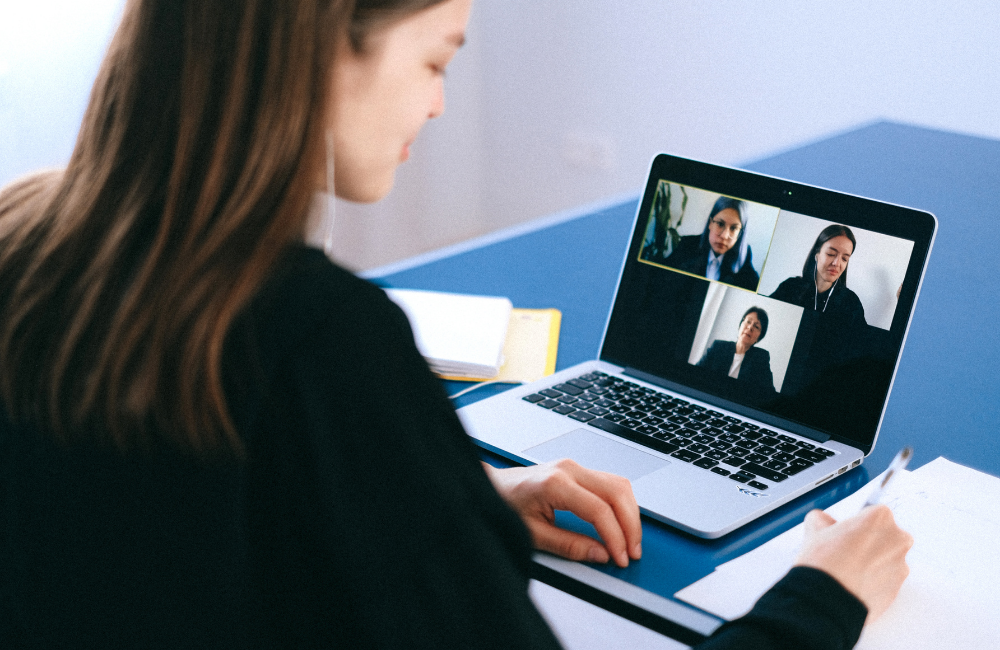 woman in front of computer in virtual meeting