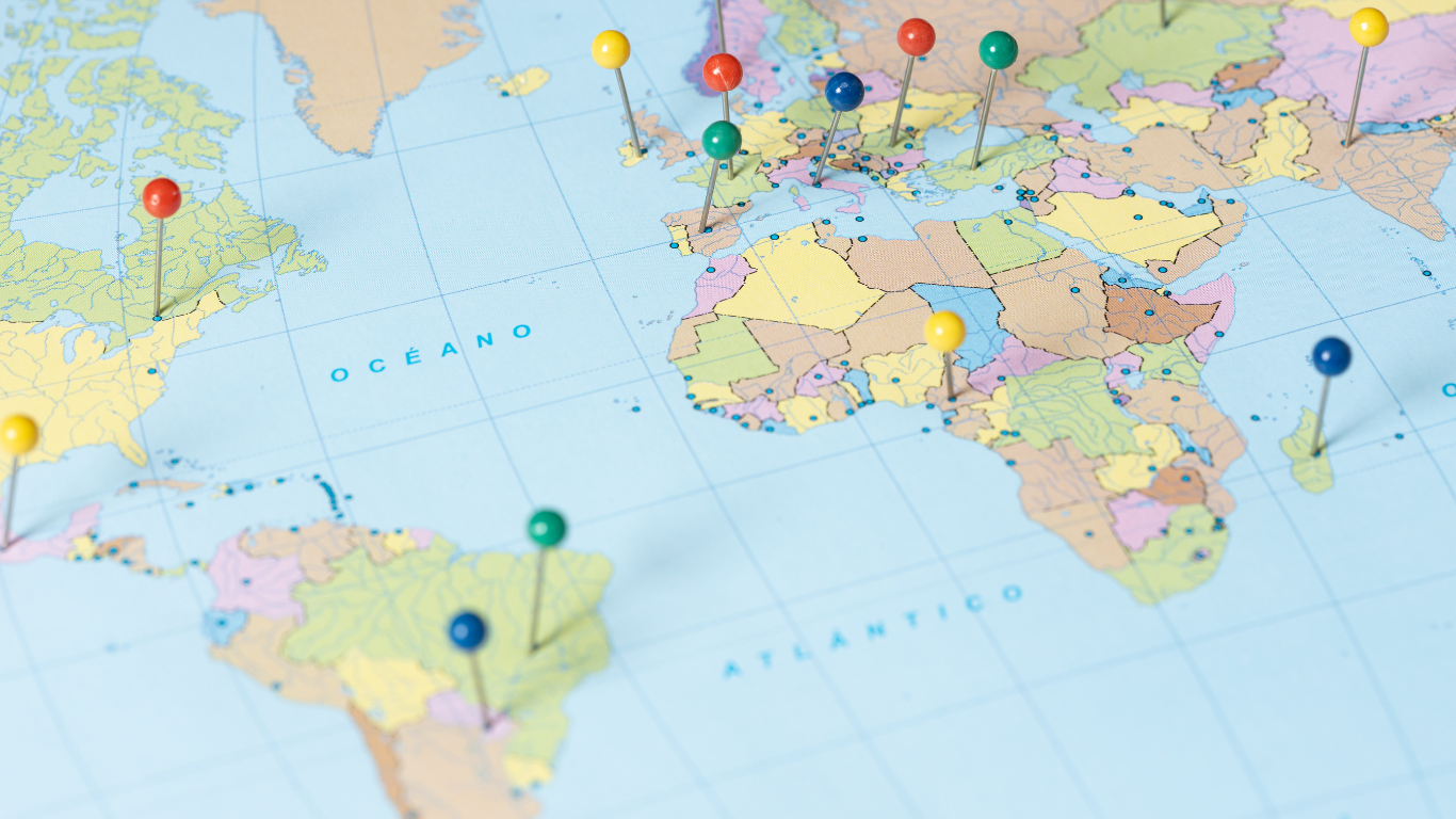 World map with pushpins on different locations.
